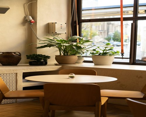 A modern cozy creative office space located in center of Bucharest with wooden tables